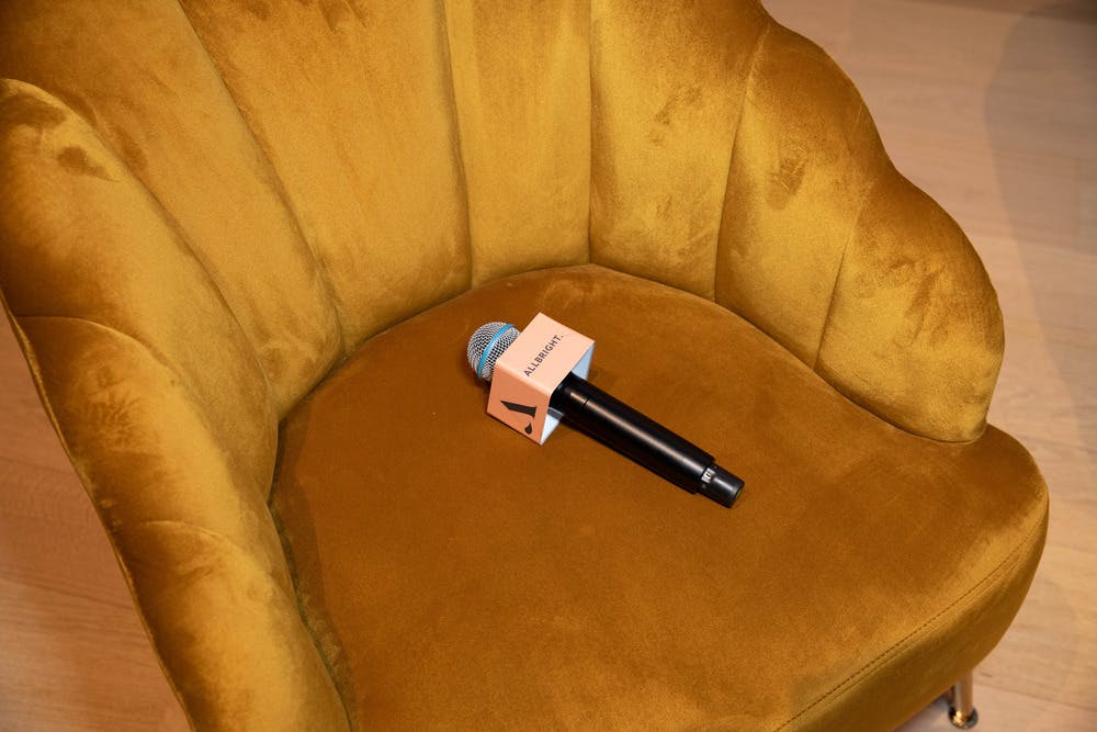 AllBright microphone lying on yellow velvet chair